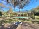 Stunning screened-in pool area complemented by a relaxing tree swing, creating a serene outdoor oasis at 3435 Black Willow Trl, Deland, FL 32724