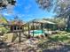 An inviting screened-in pool is set against a backdrop of lush greenery, offering both privacy and beauty at 3435 Black Willow Trl, Deland, FL 32724