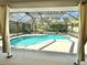 Screened-in pool with clear blue water surrounded by lush landscaping at 3435 Black Willow Trl, Deland, FL 32724