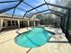 Outdoor screened in pool with patio furniture and blue water at 3435 Black Willow Trl, Deland, FL 32724