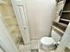 Toilet adjacent to a set of shelves and open closet space at 3435 Black Willow Trl, Deland, FL 32724