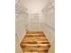 Functional walk-in closet with hardwood floors, white trim, and wire shelving for efficient storage solutions at 3435 Black Willow Trl, Deland, FL 32724
