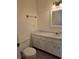 Neutral toned bathroom with a white single sink vanity and white toilet at 36 Fairway Ct # 36, Deland, FL 32724