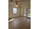 Living room with tiled floors, a ceiling fan, and glass doors leading to a patio at 36 Fairway Ct # 36, Deland, FL 32724