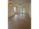 Open living room with tiled floors, a ceiling fan, and glass doors leading to a patio at 36 Fairway Ct # 36, Deland, FL 32724