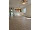 Spacious living room with tiled floors, a ceiling fan, and an open view to the kitchen at 36 Fairway Ct # 36, Deland, FL 32724