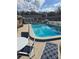 Sparkling community pool with plenty of seating and lounge chairs at 36 Fairway Ct # 36, Deland, FL 32724