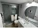 Bathroom with a shower, toilet, granite vanity top, and a large mirror at 3801 S Atlantic Ave # Ut125, New Smyrna Beach, FL 32169