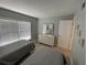 Bedroom featuring two beds, a dresser, art on the walls, and a window with blinds at 3801 S Atlantic Ave # Ut125, New Smyrna Beach, FL 32169