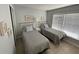 Bedroom featuring two beds, art on the walls, and a window with blinds at 3801 S Atlantic Ave # Ut125, New Smyrna Beach, FL 32169