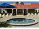 Hot tub with white chairs, arches, and a partial view of the building exterior at 3801 S Atlantic Ave # Ut125, New Smyrna Beach, FL 32169