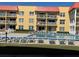 Community pool with plenty of chairs for sunbathing and relaxation at 3801 S Atlantic Ave # Ut125, New Smyrna Beach, FL 32169