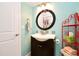 Bright bathroom with a black vanity, modern fixtures, and colorful accessories, perfect for refreshing at 4035 Saxon Dr # A3, New Smyrna Beach, FL 32169