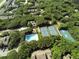 Aerial view of the community featuring tennis courts, a pool, and lush tree coverage at 4322 Sea Mist Dr # 4322, New Smyrna Beach, FL 32169