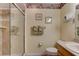 Bathroom showcasing the toilet, sink, and glass door shower at 4322 Sea Mist Dr # 4322, New Smyrna Beach, FL 32169