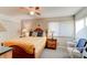 Comfortable bedroom featuring a ceiling fan, lamps, and large window allowing natural light at 4322 Sea Mist Dr # 4322, New Smyrna Beach, FL 32169