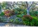 Beautiful landscaping featuring lush greenery, mature trees, and vibrant flowering bushes that add to the property's curb appeal at 4322 Sea Mist Dr # 4322, New Smyrna Beach, FL 32169
