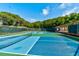Community pickleball court surrounded by lush trees with an overhead sun shade at 4322 Sea Mist Dr # 4322, New Smyrna Beach, FL 32169