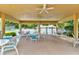 Covered picnic area featuring ceiling fans and multiple tables with chairs overlooking the pool at 4322 Sea Mist Dr # 4322, New Smyrna Beach, FL 32169