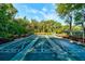 Community shuffleboard court surrounded by lush trees and seating at 4322 Sea Mist Dr # 4322, New Smyrna Beach, FL 32169