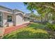 Exterior view of a house with a screened-in porch and a red wooden walkway in the backyard at 4624 Van Kleeck Dr, New Smyrna Beach, FL 32169