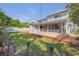 Home's exterior with a screened porch and a backyard featuring a pool and red wooden deck at 4624 Van Kleeck Dr, New Smyrna Beach, FL 32169