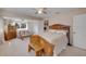 Spacious bedroom with a ceiling fan, a seating area and abundant natural light at 4624 Van Kleeck Dr, New Smyrna Beach, FL 32169