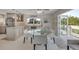 Bright dining area with stainless steel appliances and outdoor access to a deck overlooking lush greenery at 4624 Van Kleeck Dr, New Smyrna Beach, FL 32169