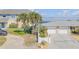 Well-maintained home with a two-car garage, mature landscaping, and a driveway at 4624 Van Kleeck Dr, New Smyrna Beach, FL 32169
