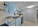 Well lit kitchen area with a double sink and ample cabinet space at 4624 Van Kleeck Dr, New Smyrna Beach, FL 32169