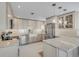 Spacious kitchen with stainless steel appliances, sleek cabinetry, granite countertops, and a farmhouse sink at 4624 Van Kleeck Dr, New Smyrna Beach, FL 32169