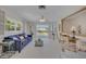 Bright living room features large windows, balcony access, and neutral paint at 4624 Van Kleeck Dr, New Smyrna Beach, FL 32169