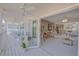 Spacious covered patio with ceiling fans and a white railing, adjacent to the home's interior at 4624 Van Kleeck Dr, New Smyrna Beach, FL 32169