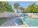 Backyard with a pool, spa, brick patio, outdoor seating, and tropical landscaping at 4624 Van Kleeck Dr, New Smyrna Beach, FL 32169
