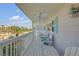 Comfortable outdoor porch with ceiling fans and white Adirondack chairs featuring ocean-themed pillows at 4624 Van Kleeck Dr, New Smyrna Beach, FL 32169