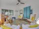Relaxing porch with comfortable seating and bright citrus rug at 4624 Van Kleeck Dr, New Smyrna Beach, FL 32169