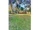 Expansive backyard featuring mature trees providing ample shade, perfect for outdoor activities and relaxation at 485 Merrimac Dr, Port Orange, FL 32127