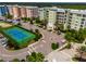 Spacious community featuring a tennis court, ample parking, palm trees, and colorful condos at 5 Riverwalk Dr # 506, New Smyrna Beach, FL 32169