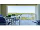 Relaxing balcony with seating area and a scenic view of the river and lush greenery at 5 Riverwalk Dr # 506, New Smyrna Beach, FL 32169