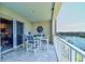 Inviting balcony with a table and chairs overlooking the water and a community boat dock at 5 Riverwalk Dr # 506, New Smyrna Beach, FL 32169