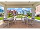 Inviting covered lounge with patio furniture overlooking a scenic bocce ball court and condos at 5 Riverwalk Dr # 506, New Smyrna Beach, FL 32169