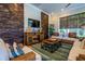 Cozy common room with a rustic wood accent wall, wicker furniture, and a vibrant area rug for a relaxing atmosphere at 5 Riverwalk Dr # 506, New Smyrna Beach, FL 32169