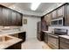 Modern kitchen featuring dark cabinets, stainless appliances, and natural stone countertop at 5 Riverwalk Dr # 506, New Smyrna Beach, FL 32169