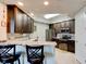 Well-equipped kitchen with breakfast bar, stainless steel appliances and dark cabinets at 5 Riverwalk Dr # 506, New Smyrna Beach, FL 32169