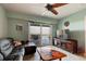 Bright living room with a ceiling fan, tile floors, a comfortable couch and an entertainment center at 5 Riverwalk Dr # 506, New Smyrna Beach, FL 32169