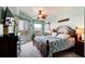 Calming main bedroom with a ceiling fan, dresser, and access to balcony with beautiful outdoor view at 5 Riverwalk Dr # 506, New Smyrna Beach, FL 32169