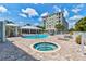 Pool area with a hot tub, cabana, and lounge chairs, ideal for relaxation and recreation at 5 Riverwalk Dr # 506, New Smyrna Beach, FL 32169