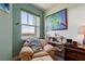 Cozy sitting area with a view of the water and a comfortable armchair and ottoman at 5 Riverwalk Dr # 506, New Smyrna Beach, FL 32169