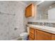 Cozy bathroom featuring patterned wallpaper, a toilet, vanity, and wooden cabinet at 526 Powers Ave, Port Orange, FL 32127