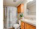 Cozy bathroom featuring a vanity with storage, a toilet, and a shower with a patterned curtain at 526 Powers Ave, Port Orange, FL 32127